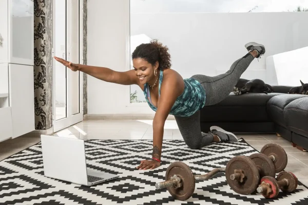 Black woman watching online tutorial during fitness workout at home Black woman watching online tutorial during fitness workout at home